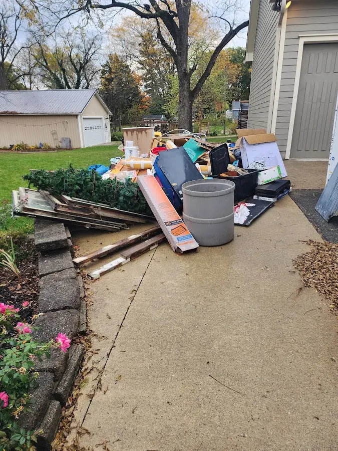Dumpster being loaded with debris for Demolition Dumpster Rental in Sturtevant